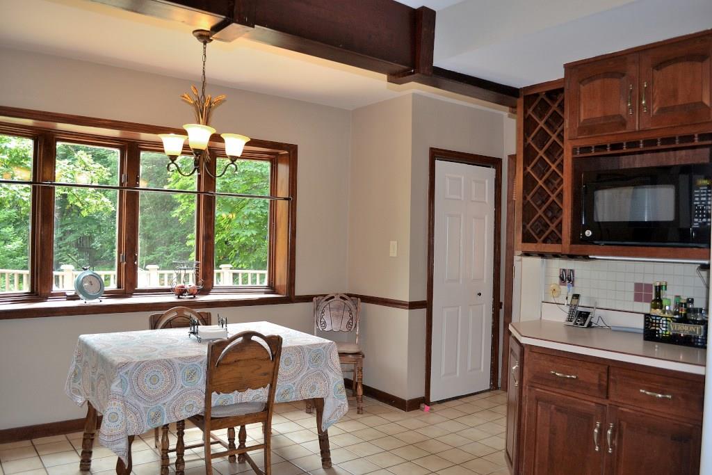 5600 Meridian Road Gibsonia, PA 15044 - Photo 12 of 25 The large eating area is flooded with light and has views of the rear deck and yard. It's nice to have a built-in wine rack, and a large pantry, too! There is an exterior door to the right of the pantry that leads to the deck, and stairs to the yard.