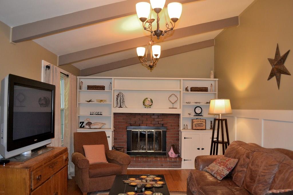 5600 Meridian Road Gibsonia, PA 15044 - Photo 3 of 25 Stunning! A vaulted beamed ceiling, built-in shelving and cabinetry, a log-burning fireplace with a brick hearth and surround, shaker wainscoating and hardwood floors create a comfy, yet beautiful room.