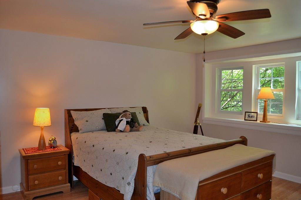 5600 Meridian Road Gibsonia, PA 15044 - Photo 21 of 25 Bedroom Four. This bedroom is on the lower level. It is part of the addition. The windows are beautiful! There is new flooring, a ceiling fan, and an en suite full bathroom, making the area perfect for a teenager, a nanny, or visiting friends or relatives.