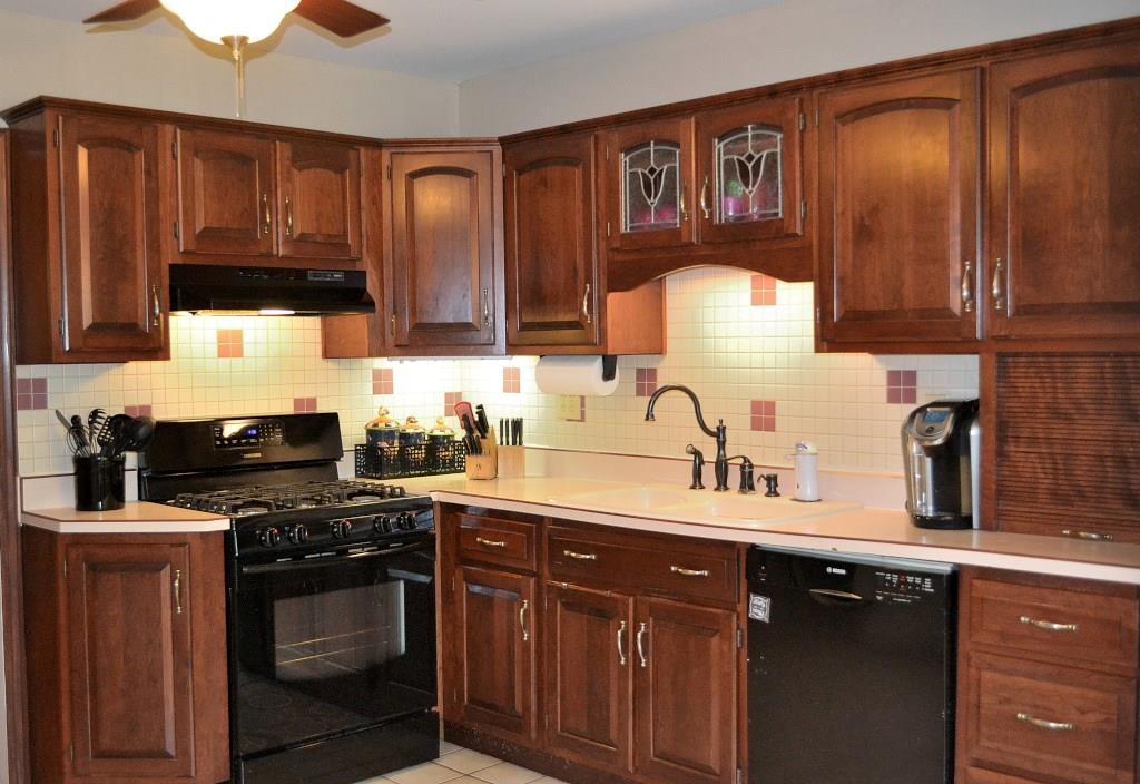 5600 Meridian Road Gibsonia, PA 15044 - Photo 4 of 25 The kitchen is loaded with cherry cabinetry! There is a five-burner gas stove, frosted glass-paneled doors and plenty of counter space.