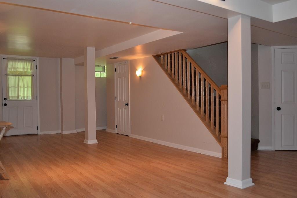 5600 Meridian Road Gibsonia, PA 15044 - Photo 5 of 25 The spacious gameroom! The door to the left leads to the patio under the deck and the rear yard. The door to the right is the laundry room. The middle door is a large closet. This level also has another storage closet, a utility room, and a large work room with a workbench, and a second furnace.