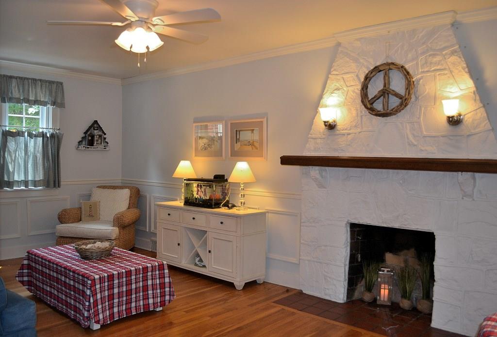 5600 Meridian Road Gibsonia, PA 15044 - Photo 10 of 25 A favorite room, for sure! The fireplace with a tile hearth and wood mantle could be log-burning or gas. (Present owners use it decoratively, though, and have burned logs in it, only once.) Hardwood, raised-paneled wainscoating, crown molding and the unique fireplace surround bring it all together in the Living Room.