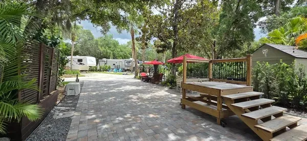 a backyard of a house with yard barbeque oven and outdoor seating
