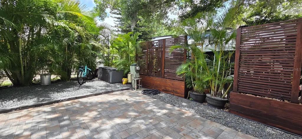 127 Stallion Lane River Ranch, FL 33867 - Photo 7 of 12 a backyard with potted plants and a large tree