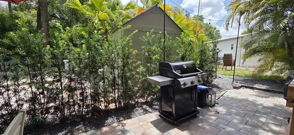 a backyard of a house with table and chairs