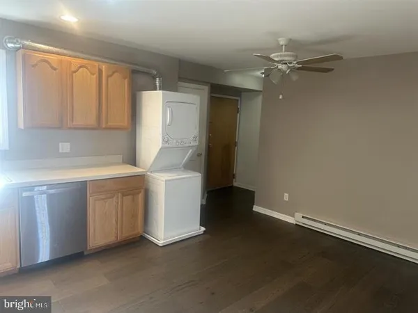 a utility room with cabinets washer and dryer