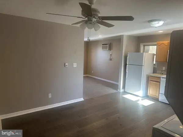 a view of a livingroom with a ceiling fan and window