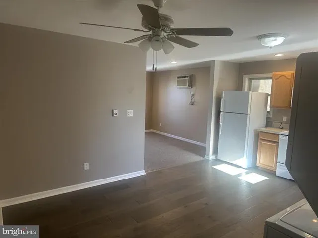 a view of a livingroom with a ceiling fan and window