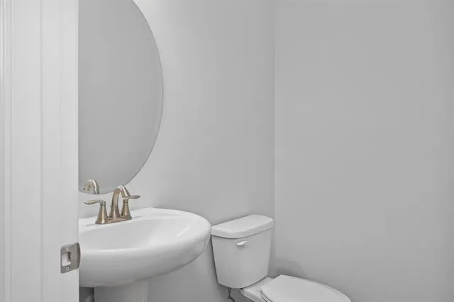 a white toilet sitting next to a white sink