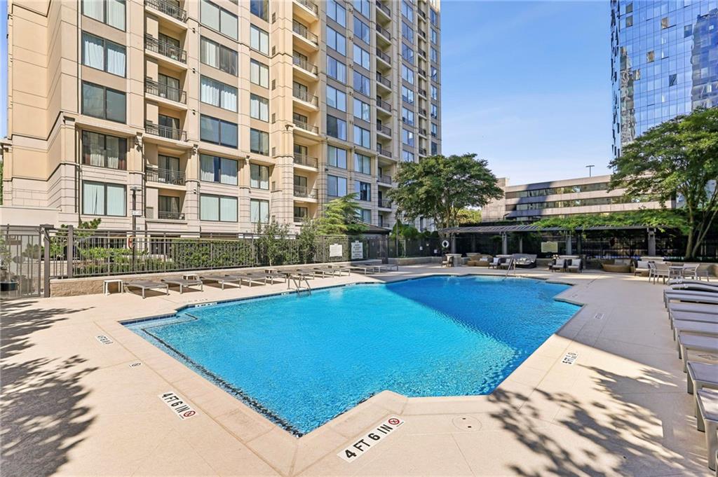 3445 Stratford Road Northeast, Unit 3105 Atlanta, GA 30326 - Photo 33 of 47 a swimming pool with outdoor seating and yard