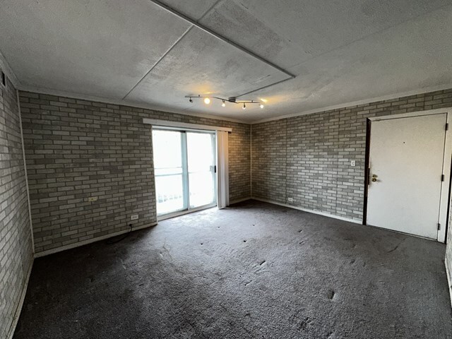 17005 Albany Avenue, Unit 102 Hazel Crest, IL 60429 - Photo 3 of 13 a view of an empty room with a window