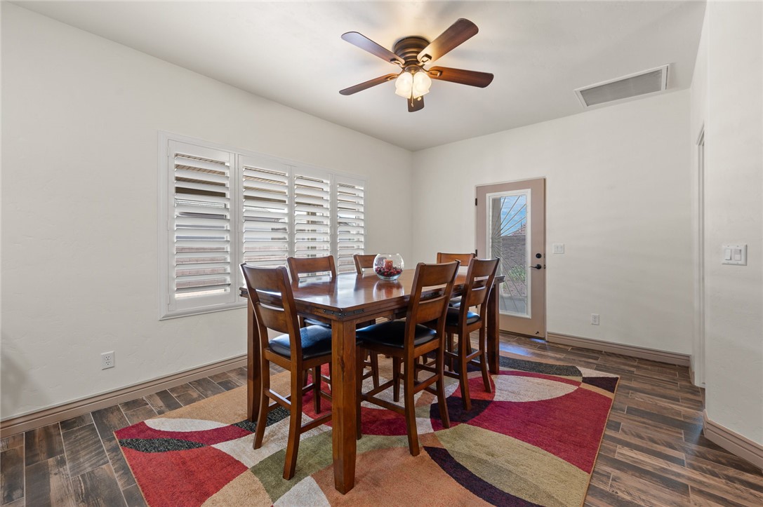 3319 Motherload Road Kingman, AZ 86401 - Photo 12 of 53 Dining room featuring plank tile flooring, plantain shutters and an exit door to the backyard