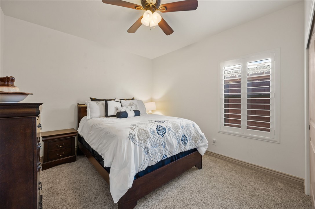 3319 Motherload Road Kingman, AZ 86401 - Photo 20 of 53 Guest bedroom featuring carpet, a ceiling fan and plantation shutters