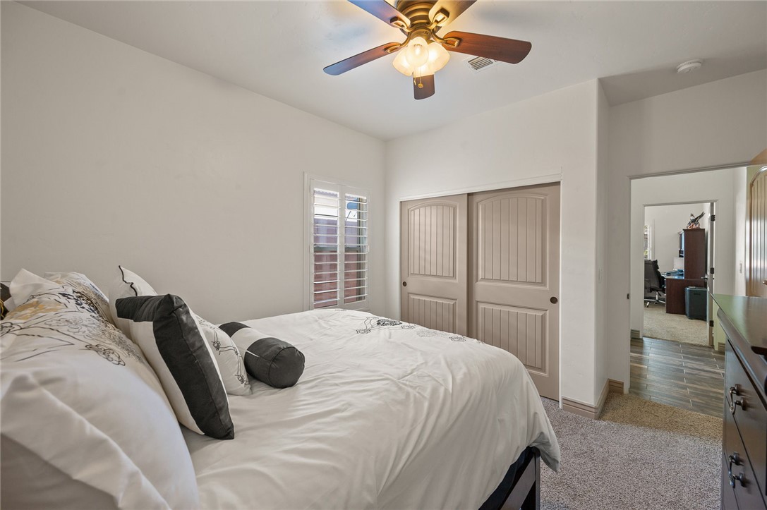 3319 Motherload Road Kingman, AZ 86401 - Photo 21 of 53 Guest bedroom featuring carpet, a ceiling fan and plantation shutters