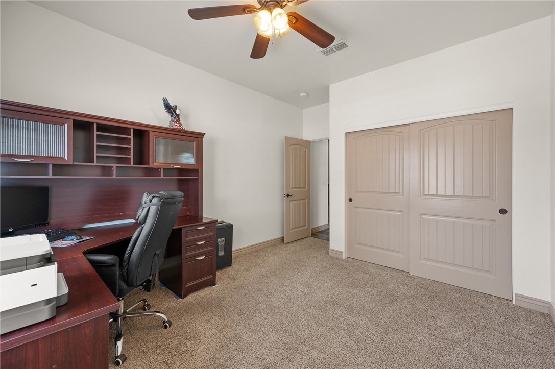 3319 Motherload Road Kingman, AZ 86401 - Photo 22 of 53 Guest bedroom featuring carpet, a ceiling fan and raised designed closet doors