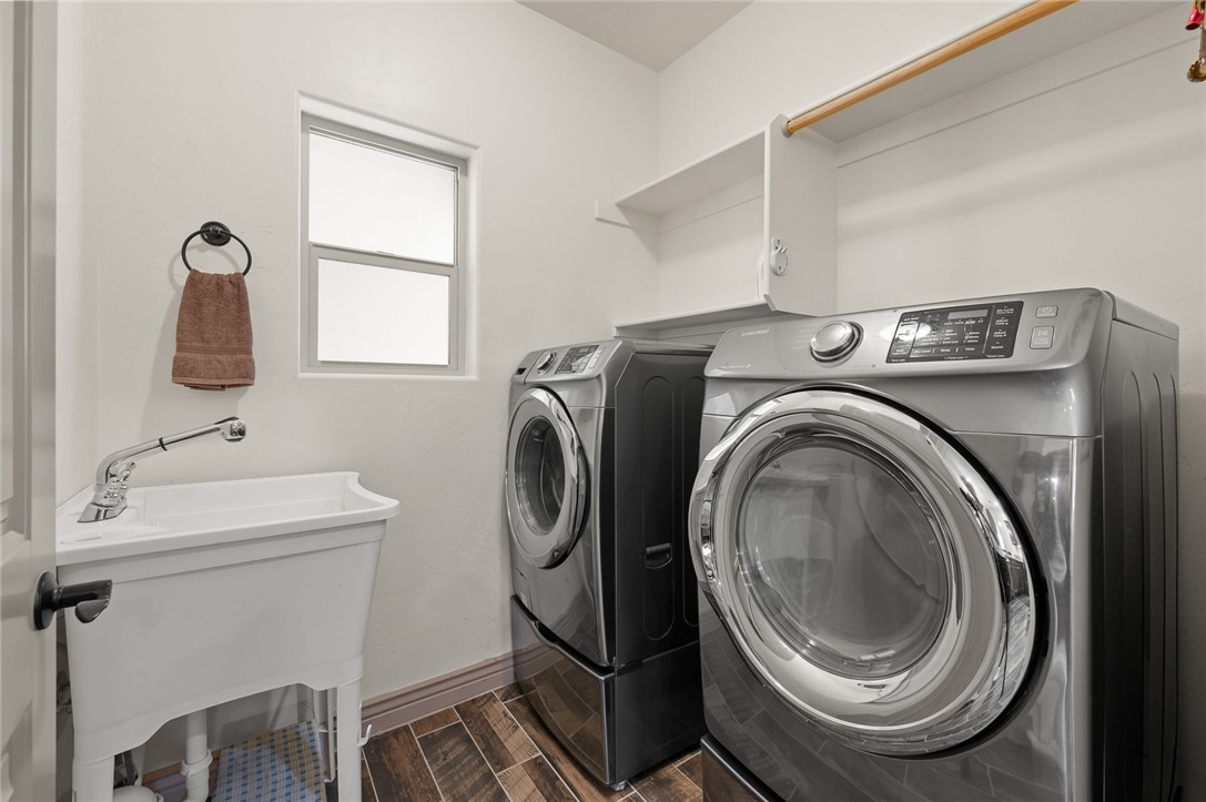 3319 Motherload Road Kingman, AZ 86401 - Photo 26 of 53 Washroom featuring independent front load washer and dryer, a sink, built in shelves and plank tile flooring