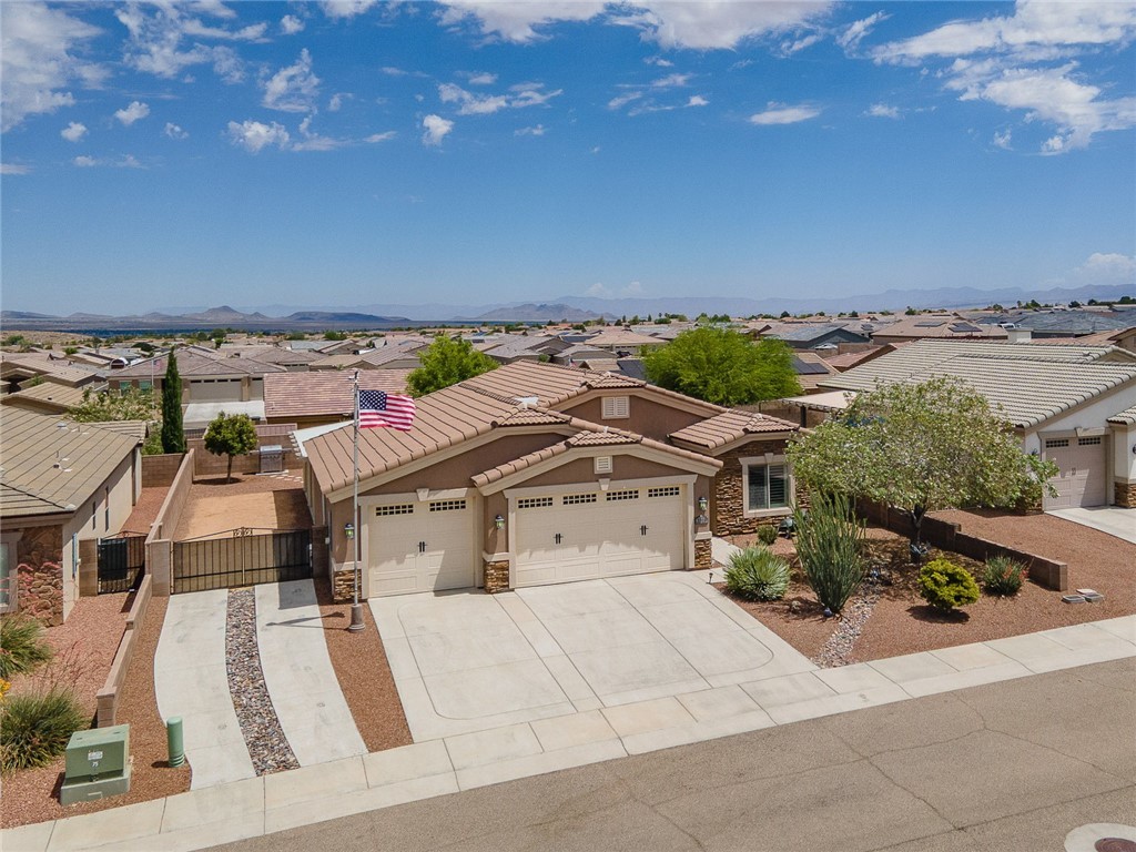 3319 Motherload Road Kingman, AZ 86401 - Photo 3 of 53 Ariel View of front of home, 3 car garage, beautiful mature landscaping, professionally installed American flag and RV parking