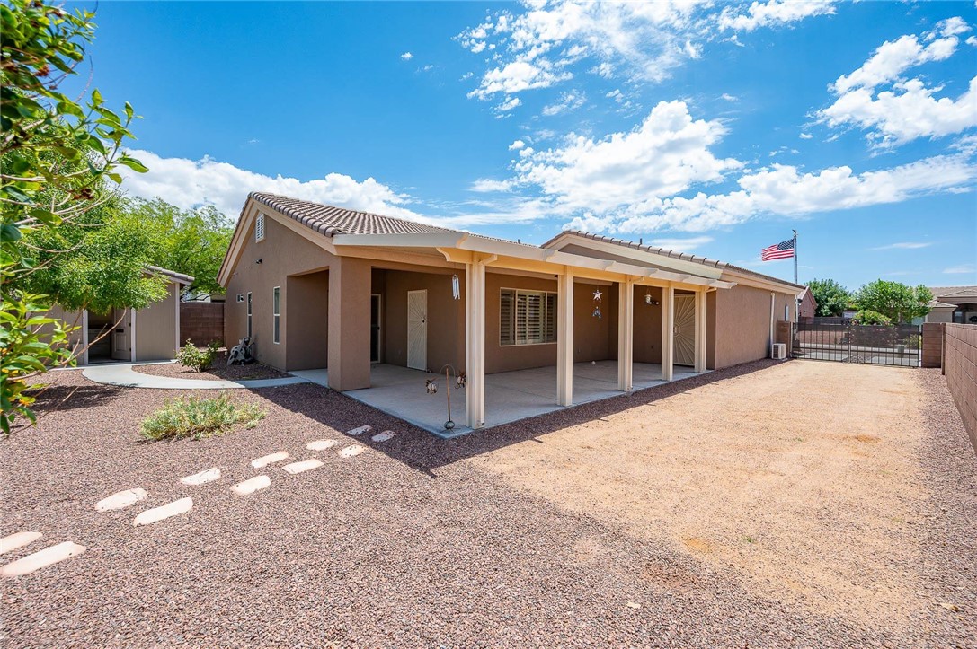 3319 Motherload Road Kingman, AZ 86401 - Photo 35 of 53 Back of home featuring RV parking, extended covered patio, mature landscaping and a shed