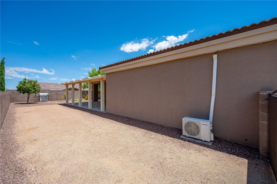 3319 Motherload Road Kingman, AZ 86401 - Photo 38 of 53 Completely fenced backyard featuring RV side parking, extended covered patio and a mini-split for garage air conditioning
