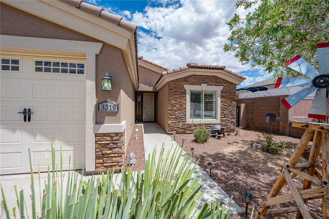 3319 Motherload Road Kingman, AZ 86401 - Photo 4 of 53 View of exterior entry featuring mature landscaping and accented stone