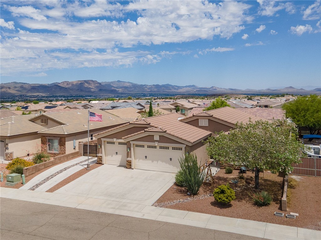 3319 Motherload Road Kingman, AZ 86401 - Photo 50 of 53 View of front of home with a residential view, stucco siding, an attached garage, driveway, RV Parking and a mountain view