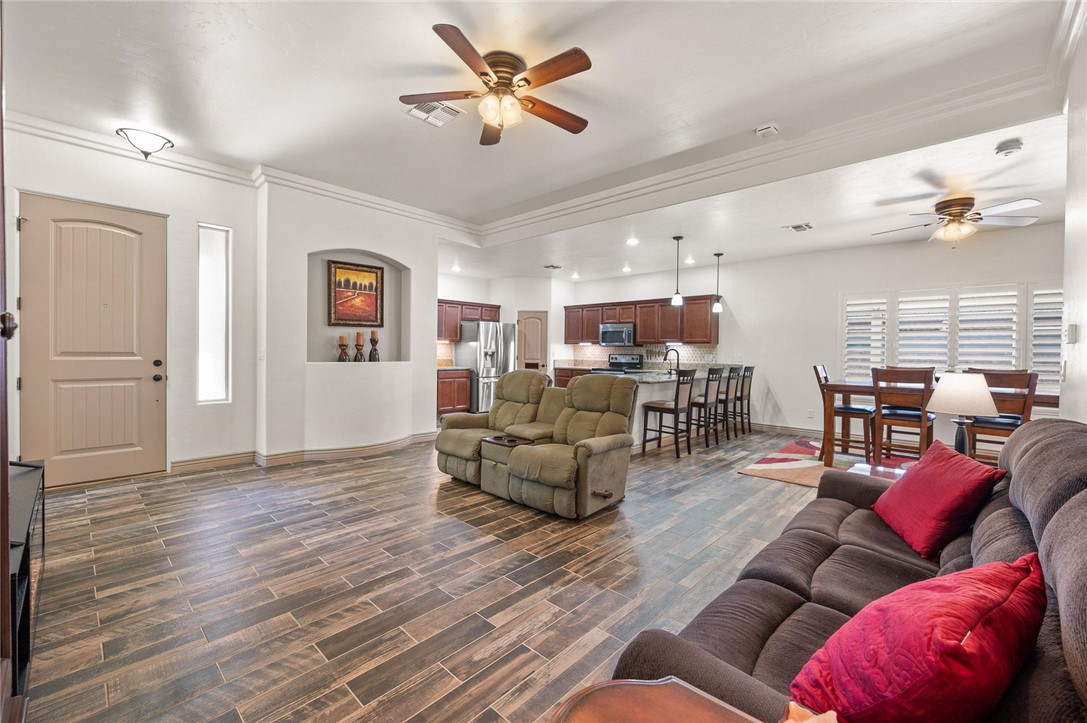 3319 Motherload Road Kingman, AZ 86401 - Photo 52 of 53 Living room featuring an open floor plan, kitchen, dining area, plank tile flooring and ceiling fans