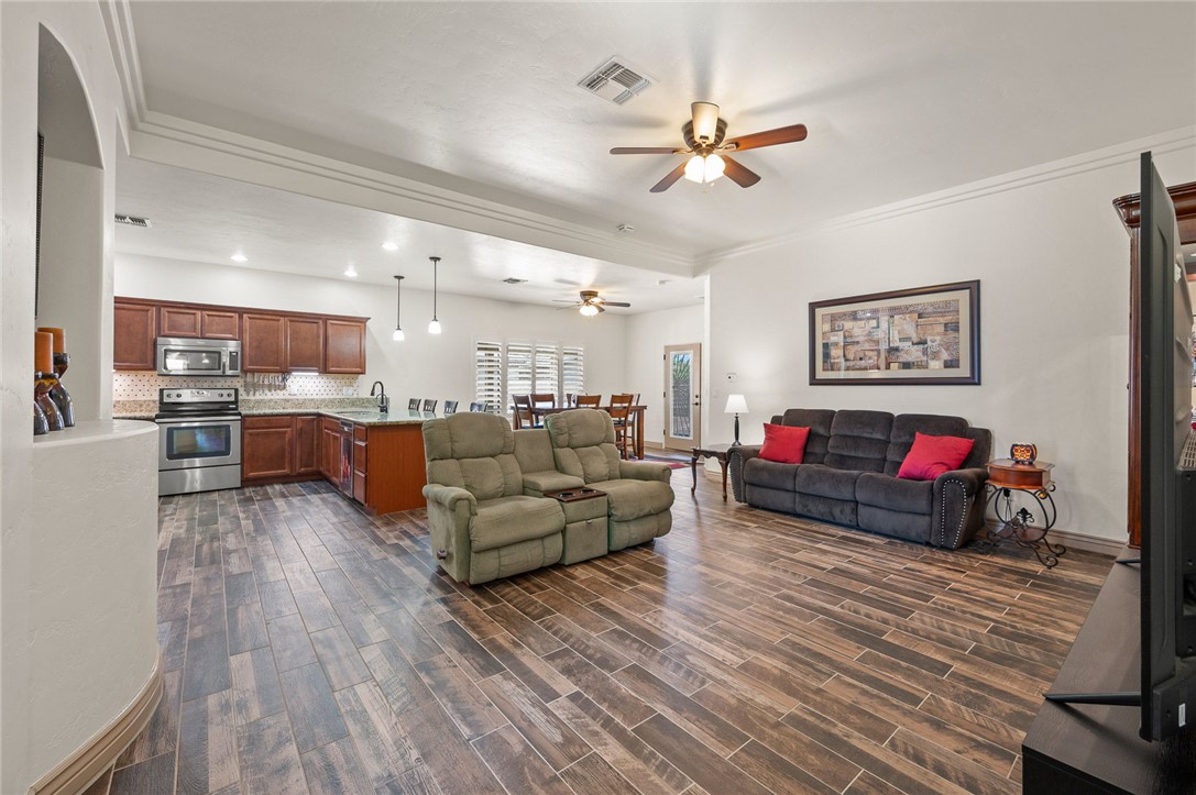 3319 Motherload Road Kingman, AZ 86401 - Photo 53 of 53 Living room featuring an open floor plan, kitchen, dining area, plank tile flooring and ceiling fans