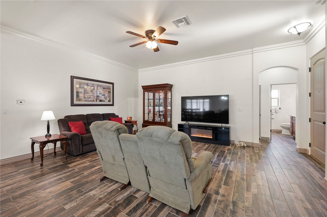 3319 Motherload Road Kingman, AZ 86401 - Photo 5 of 53 Living area featuring arched walkways leading into guest quarters, a ceiling fan and plank tile flooring