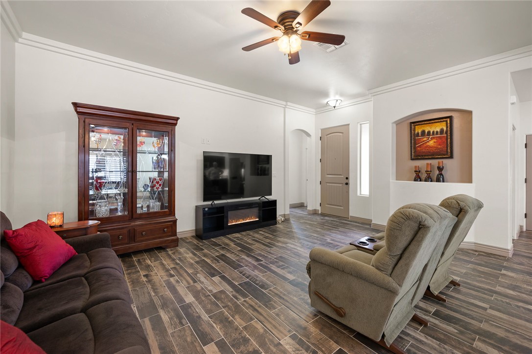 3319 Motherload Road Kingman, AZ 86401 - Photo 6 of 53 Living area featuring arched walkways leading into guest quarters, a ceiling fan and plank tile flooring