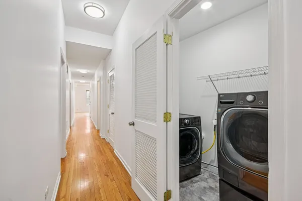 a view of a hallway with washer and dryer