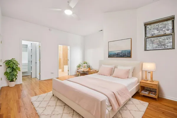 a bedroom with a large bed and a chandelier