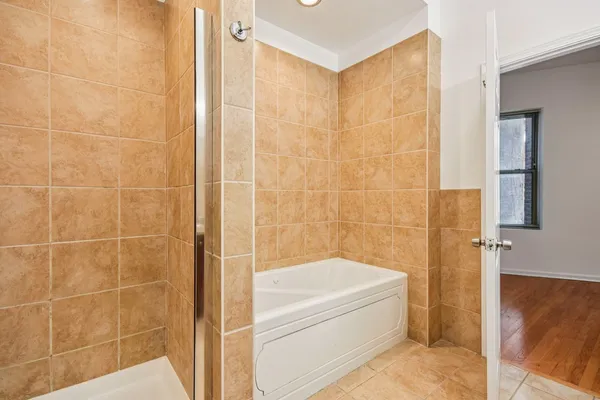 a bathroom with a bathtub and a shower