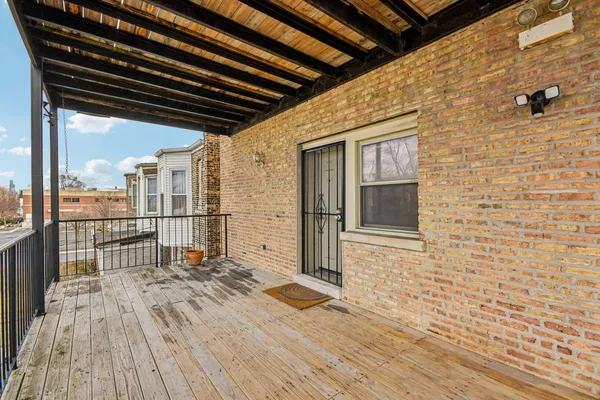 a view of a porch with wooden floor and fence