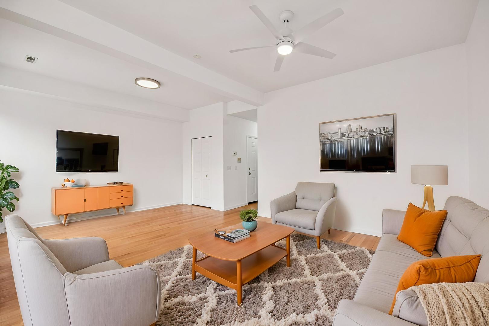 4644 South Prairie Avenue, Unit 2N Chicago, IL 60653 - Photo 3 of 25 a living room with furniture and a flat screen tv