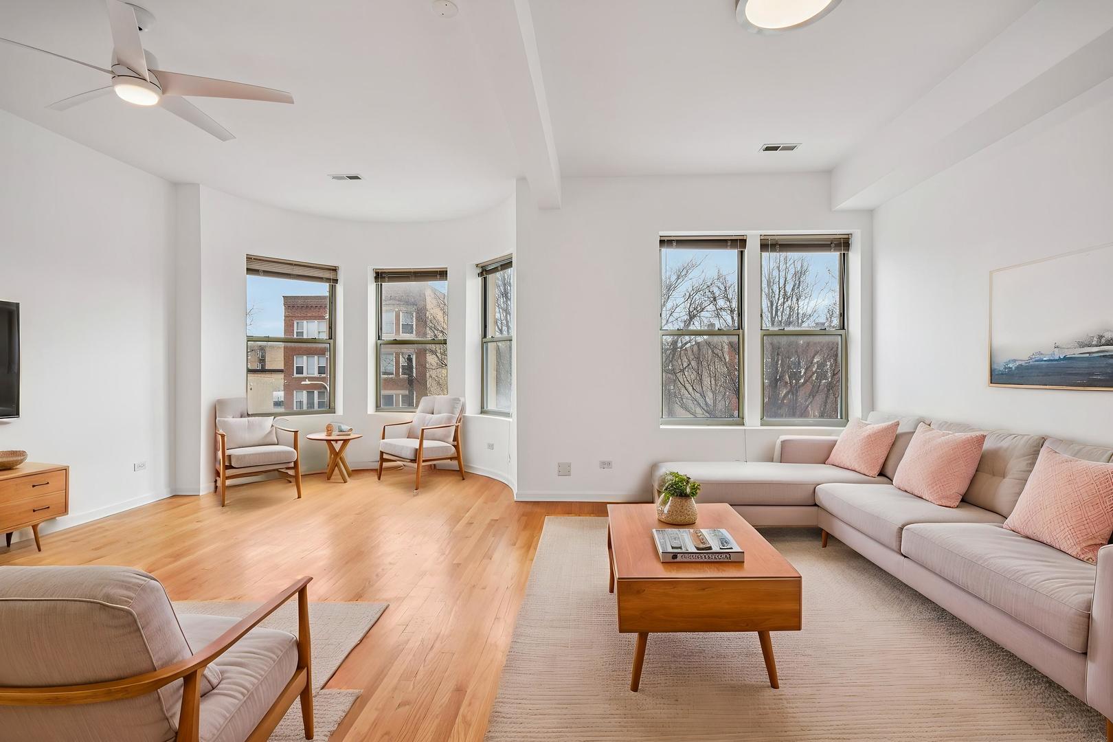 4644 South Prairie Avenue, Unit 2N Chicago, IL 60653 - Photo 5 of 25 a living room with furniture and a large window
