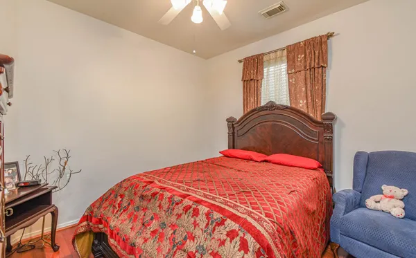 a bedroom with a bed and a chandelier