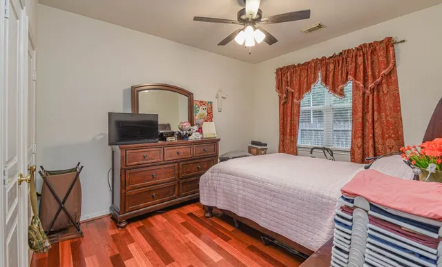 a bedroom with a large bed and a chandelier