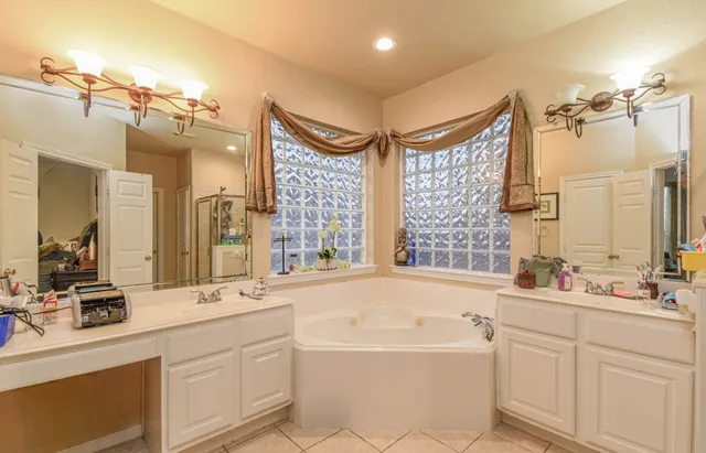 a bathroom with a bathtub and a shower
