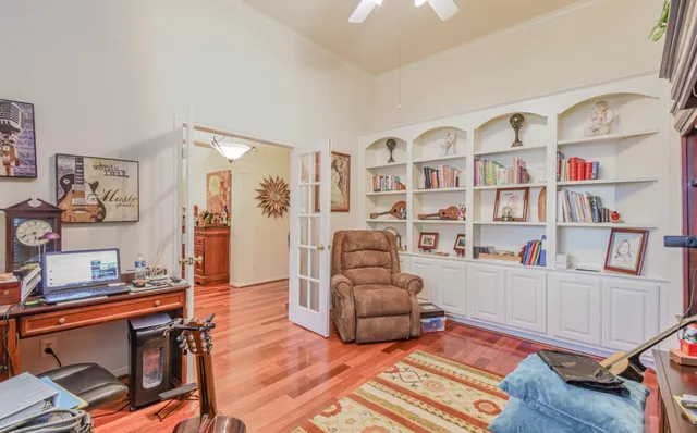 a living room with furniture and a book shelf