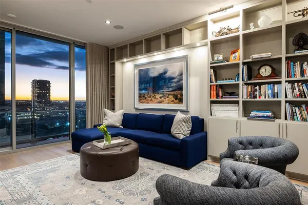 a living room with furniture and a book shelf