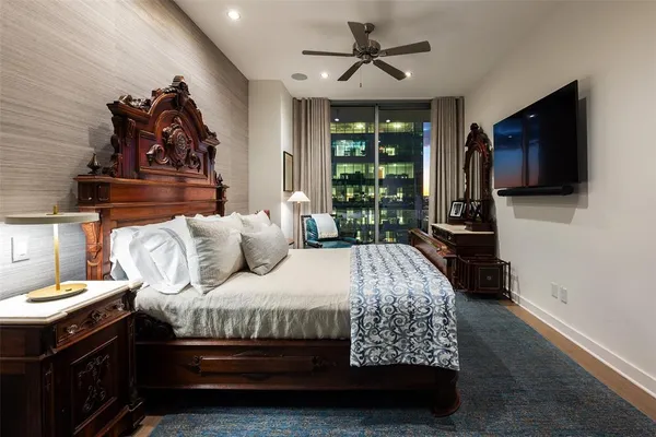 a bedroom with a bed a couch and dresser