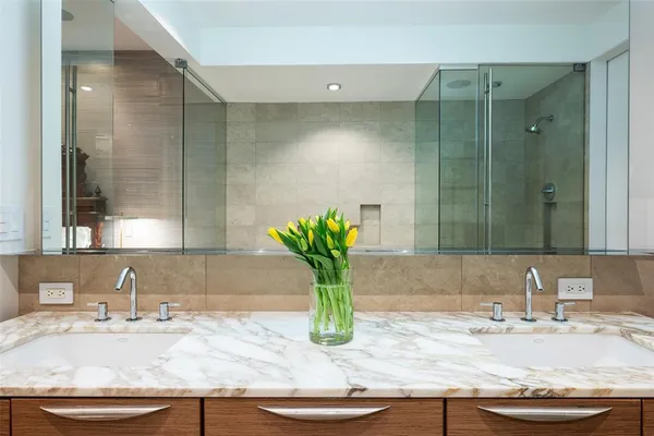 a bathroom with a granite countertop sink and a mirror