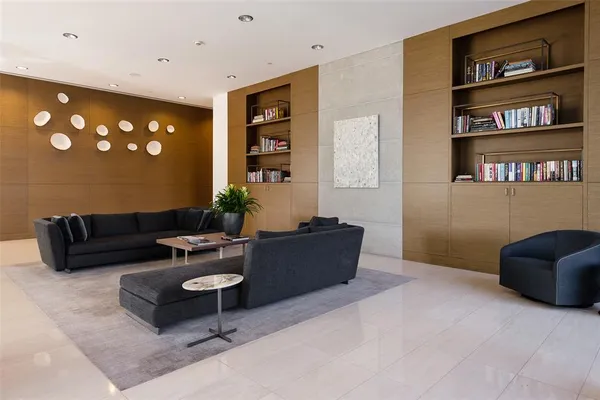 a view of a backyard with couches plants and large tree