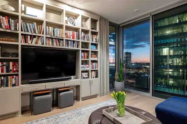 a living room with fireplace furniture and a flat screen tv