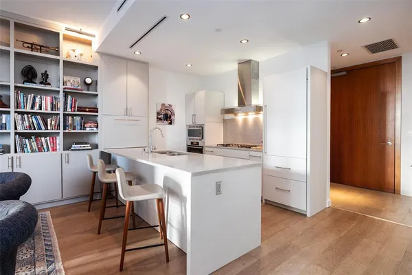 a kitchen with a table chairs refrigerator and cabinets