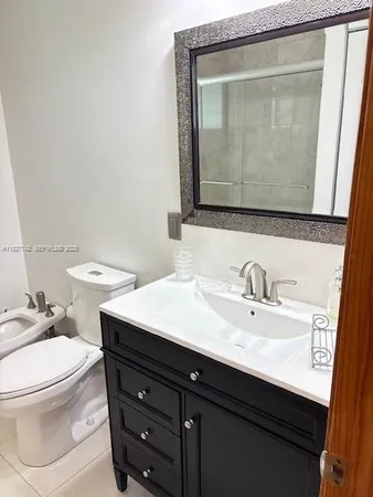 a bathroom with a sink a toilet and mirror