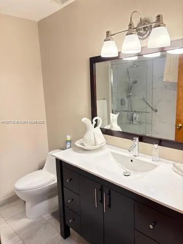 a bathroom with a sink a toilet and mirror