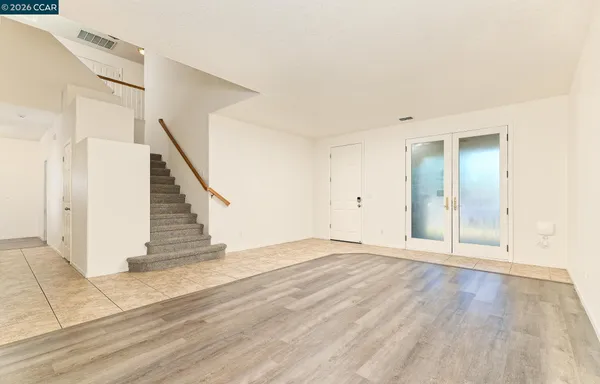 a view of an empty room with stairs