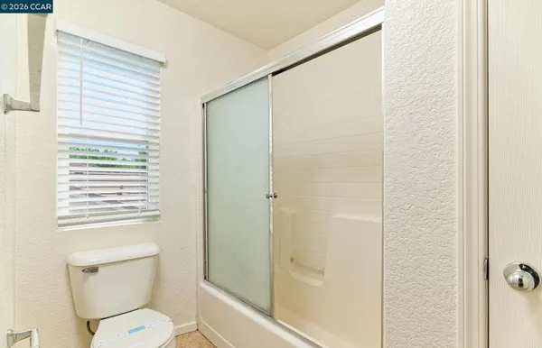 a spacious bathroom with a granite countertop sink mirror and