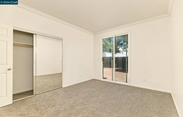 a view of a porch with a door and wooden fence